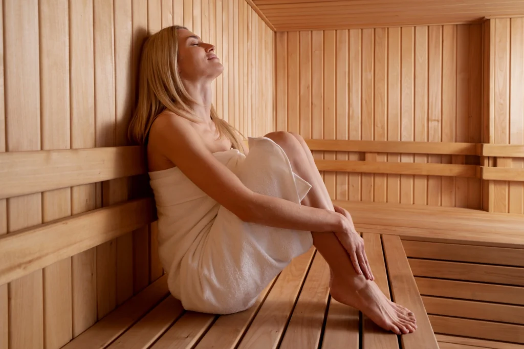A woman relaxing in Sauna and enjoying its benefits