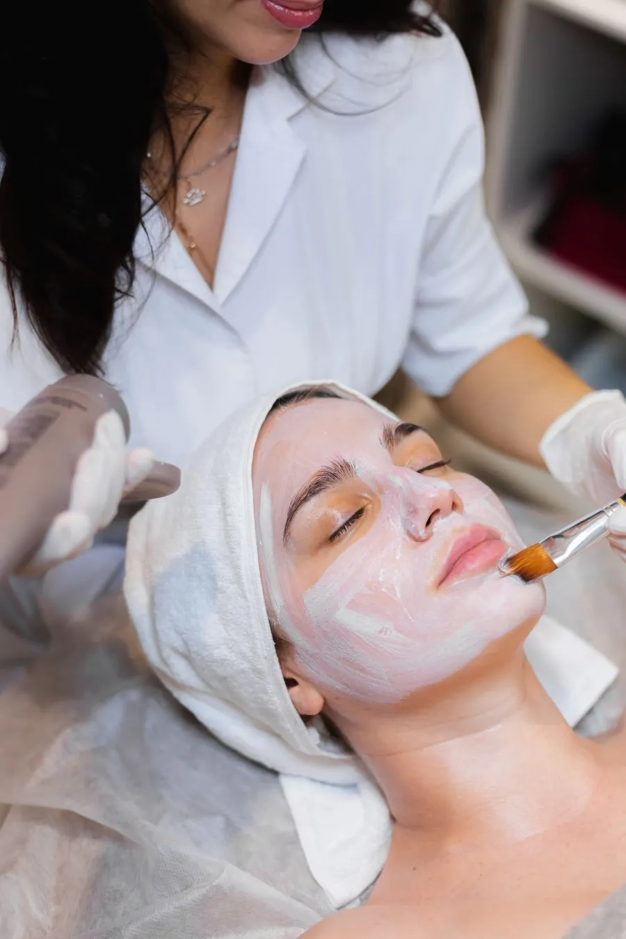 Beautician applying face mask during facial treatment at a salon in pokhara