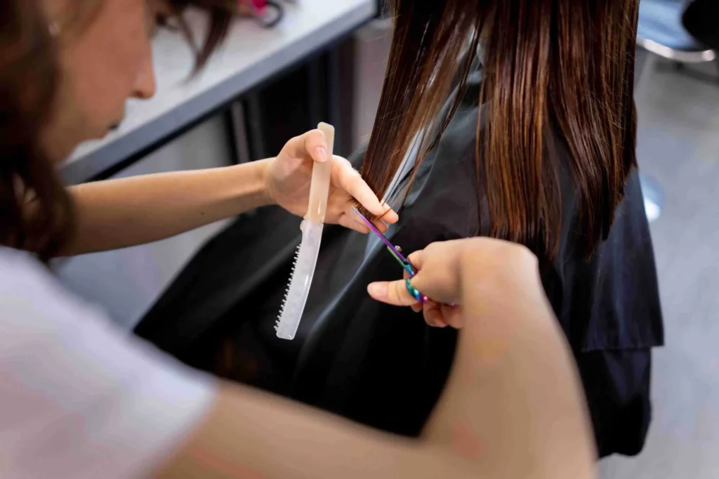 Hairdresser trimming hair to give a haircut for women
