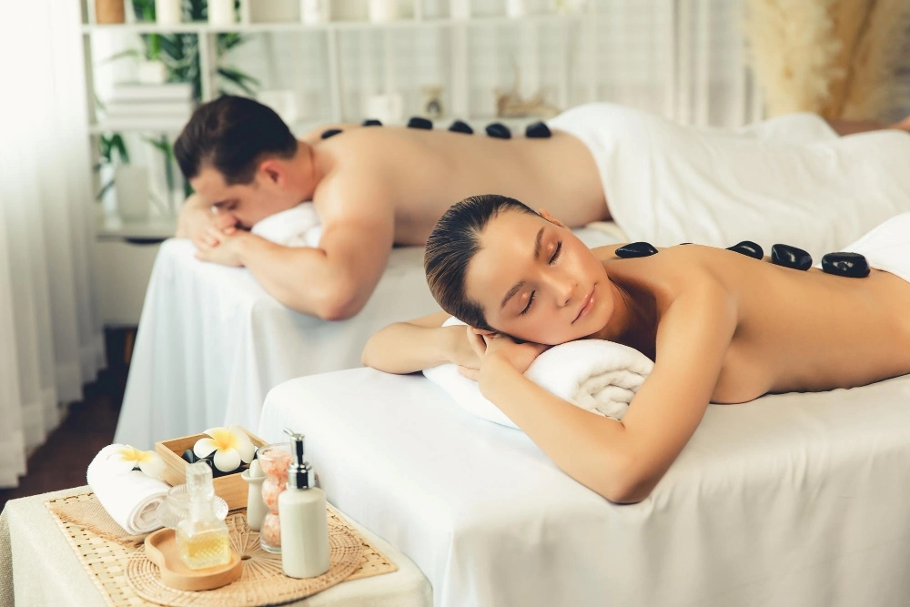 A couple enjoying hot stone massage a couple spa package