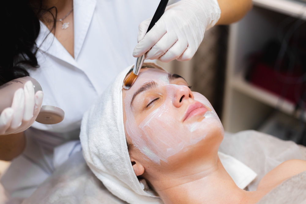 A beautician applying the faical mask to a young girl -  Facial treatments in Pokhara